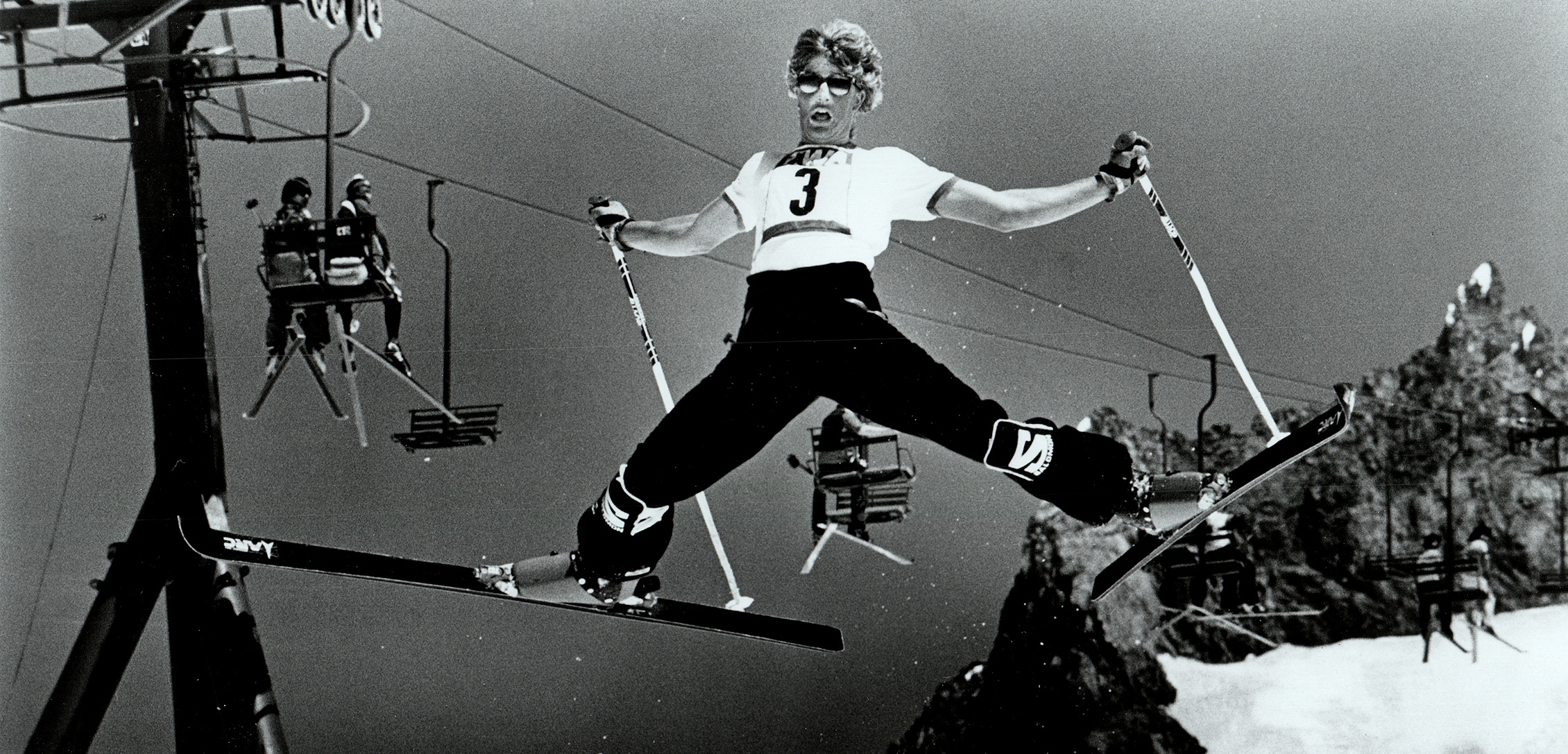 70s photo of skier in t-shirt doing a jump down Palmer Snowfield