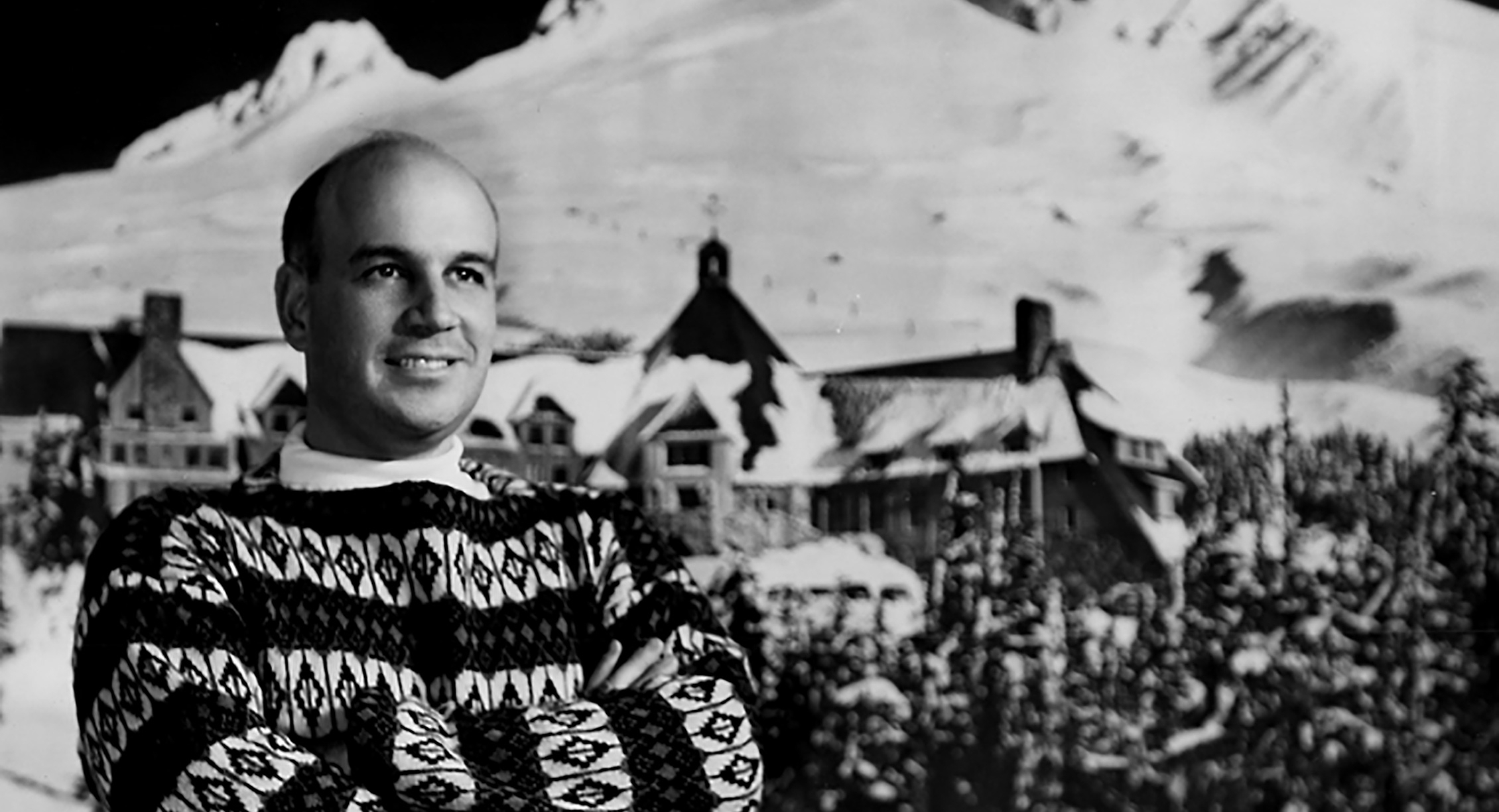 R.L. Kahnstamm standing in front of Timberline Lodge and Mt. Hood circa 1955