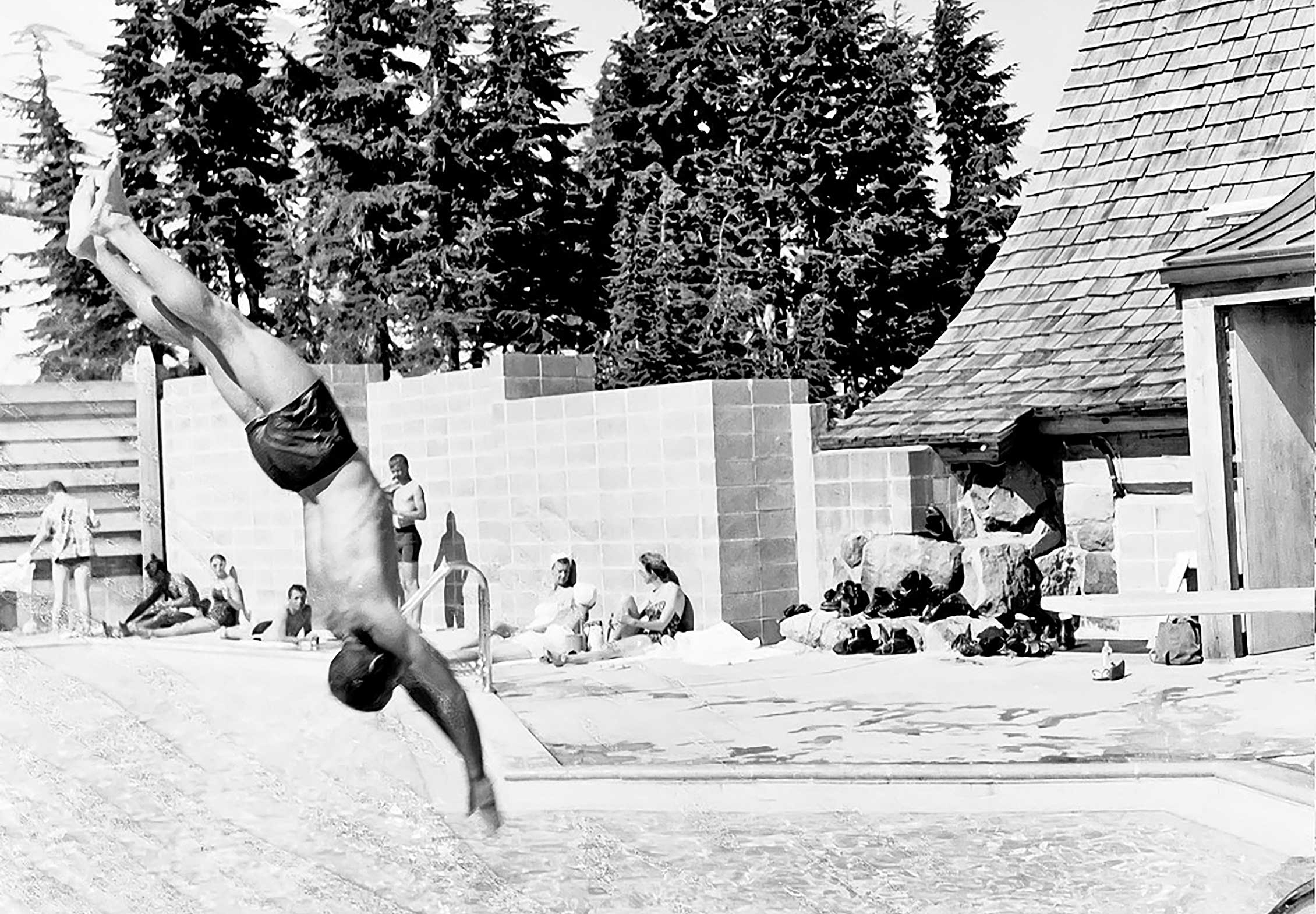 BOY DIVING INTO POOL IN THE 1950S