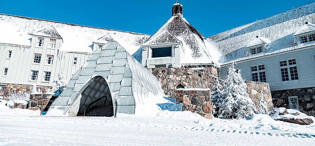 FRONT ENTRANCE OF TIMBERLINE IN EARLY WINTER WITH SNOW TUNNEL AND LIGHT DUSTING OF SNOW AND BLUE SKIES
