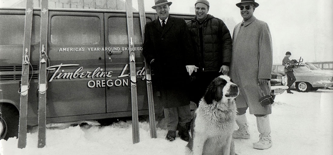 ONE OF TIMBERLINE'S ORIGINAL ST. BERNARDS STANDING WITH R.L. KOHNSTAMM AND FRIENDS IN FRONT OF A TIMBERLINE LOGO VAN AND SKIS