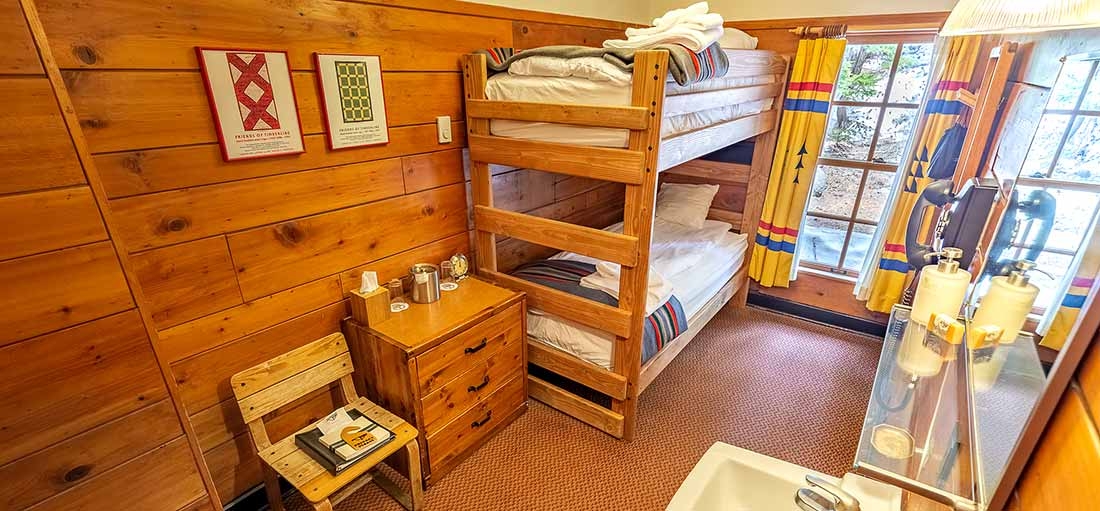 SMALL TIMBERLINE CHALET ROOM WITH TWIN BUNKS AND SMALL SINK