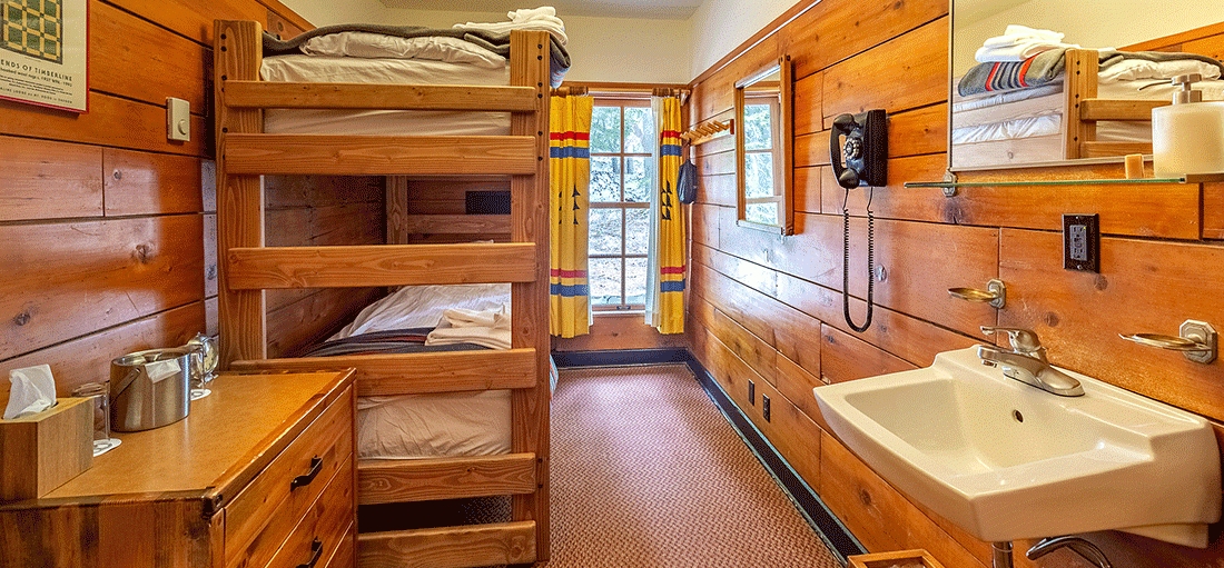 SMALL TIMBERLINE CHALET ROOM WITH TWIN BUNKS AND SMALL SINK
