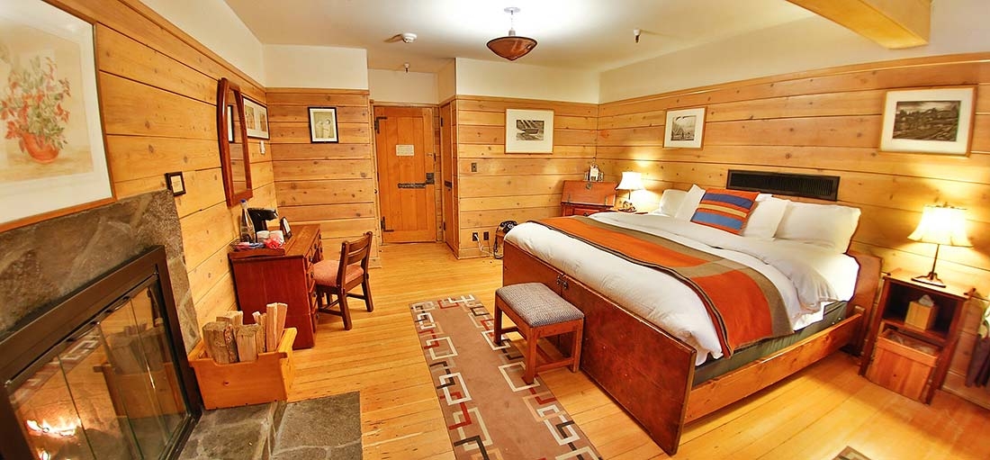 TIMBERLINE KING FIREPLACE HOTEL ROOM WITH SEATING AREA AND SPACE FOR A ROLLAWAY BED