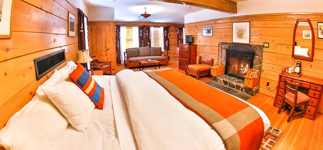 TIMBERLINE KING FIREPLACE HOTEL ROOM WITH SEATING AREA AND SPACE FOR A ROLLAWAY BED