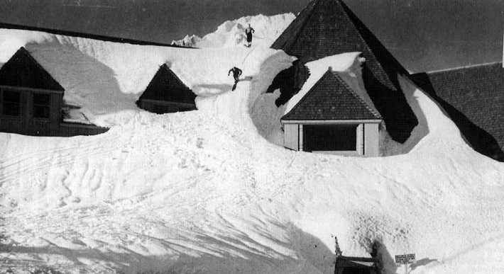 Historic photos of two skiers skiing down the snow from the roof of Timberline Lodge