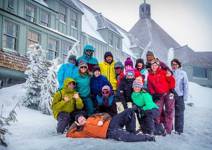 Group of skiers and snowboarders posing in front of Timberline
