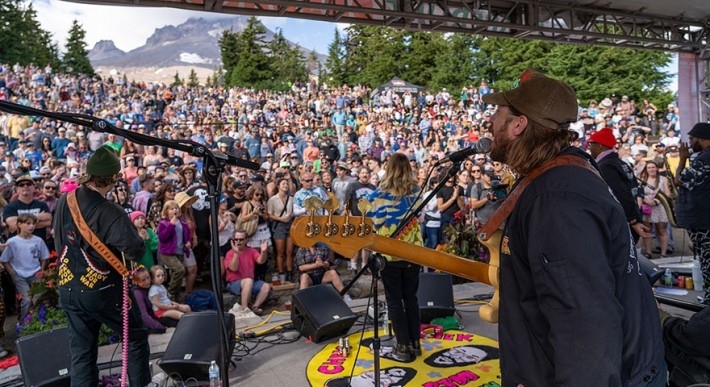 PORTUGAL. THE MAN PLAYING AT TIMBERLINE DAYDREAM WITH THE CROWD AND MT. HOOD IN THE BACKGROUND