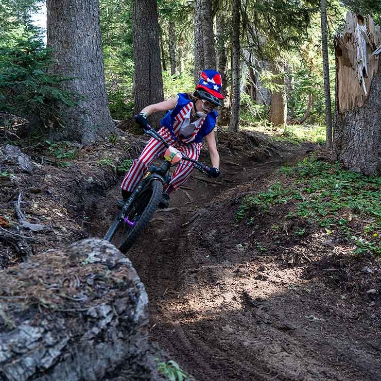 MOUNTAIN BIKER DRESSED IN UNCLE SAM COSTUME RIDING THE TIMBERLINE BIKE PARK AT THE DAYDREAM ENDURO BIKE RACE