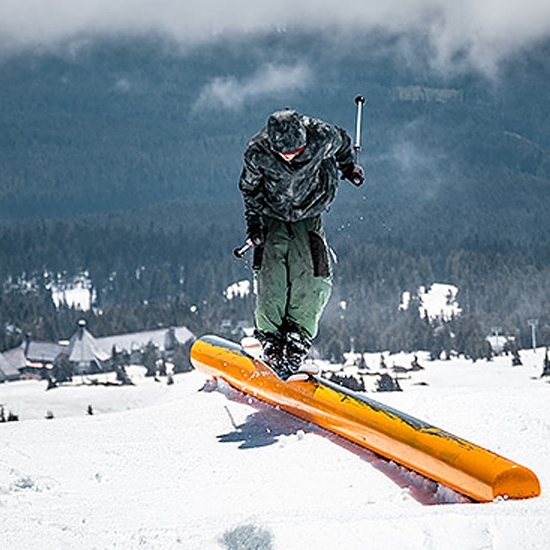 SKIER ON A RAIL OVERLOOKING TIMBERLINE LODGE