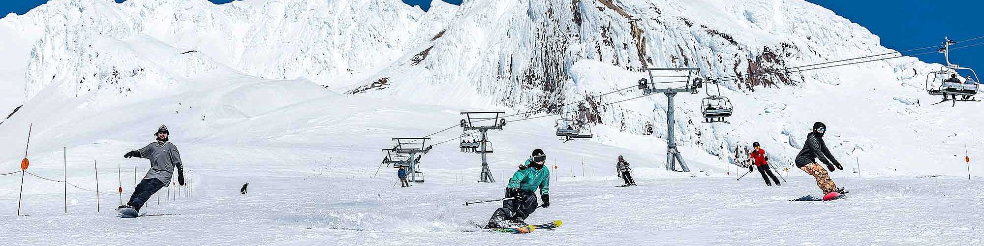 SKIERS AND SNOWBOARDERS RIDING DOWN TIMBERLINE'S PALMER IN THE SPRING