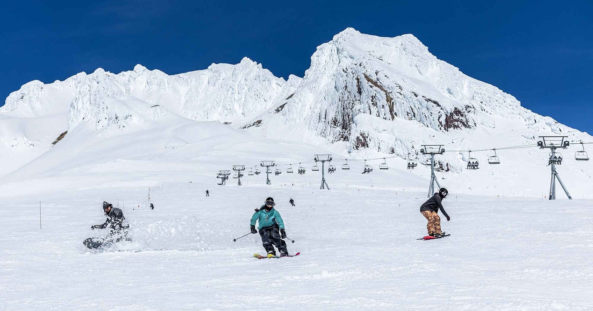 SKIERS AND SNOWBOARDERS RIDING DOWN TIMBERLINE'S PALMER IN THE SPRING
