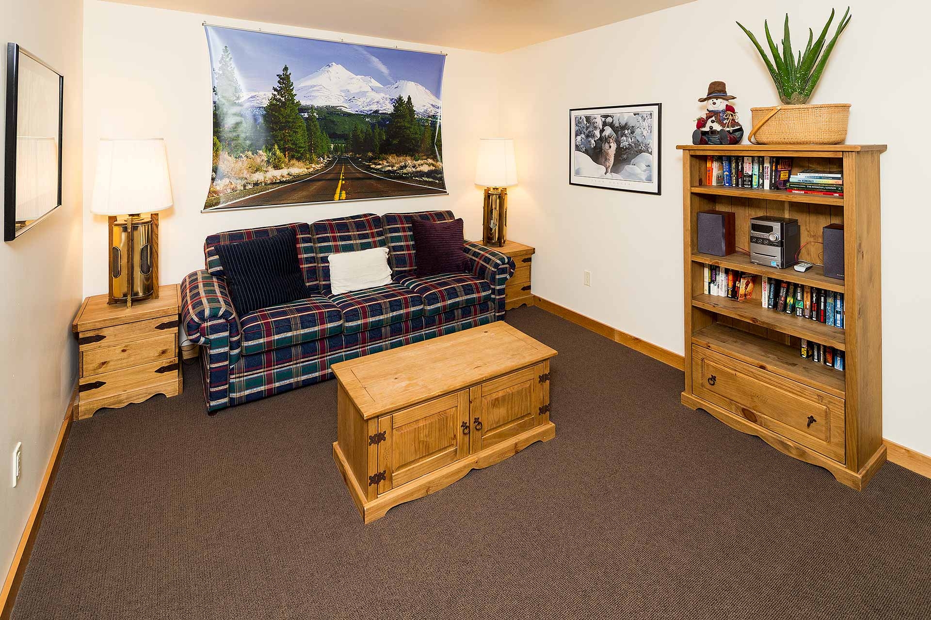 LAGC UNIT 1 LOFT SPACE SITTING AREA WITH COUCH AND BOOK SHELF