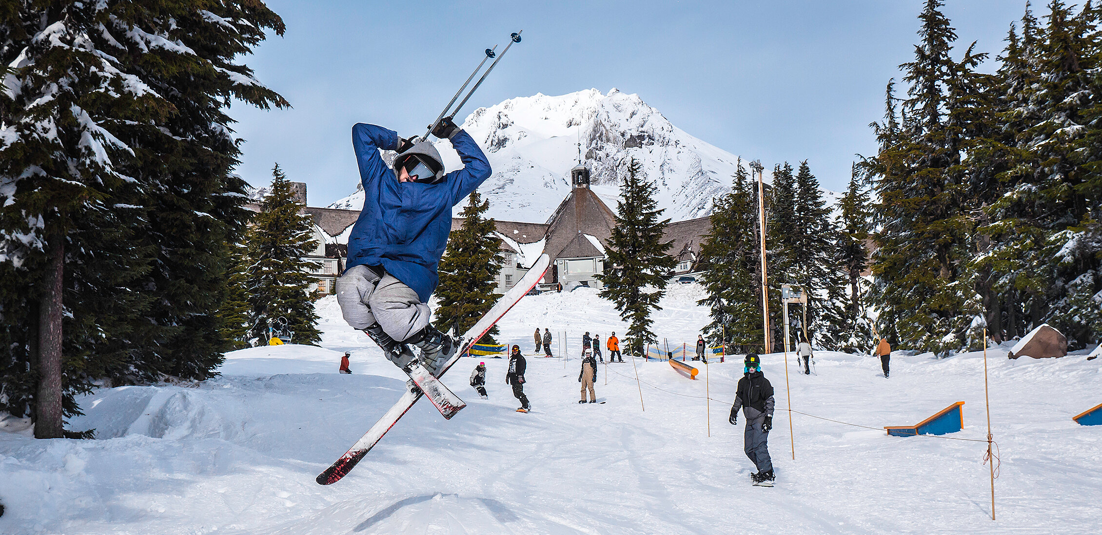 Skier jumping for joy in front of Timberline and Mt. Hood